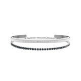 Two silver Daniel Wellington bracelets are shown: one with a polished, minimalist band engraved with the brand name, and the other a delicate tennis bracelet adorned with sparkling stones, both styled together for an elegant, contemporary look.