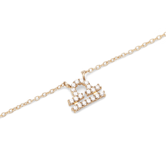 Gold chain necklace featuring a Libra zodiac pendant adorned with sparkling hand-set crystals.