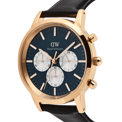 Close-up of the Iconic Chronograph Sheffield Arctic Panda Rose Gold watch by Daniel Wellington, highlighting the deep blue dial with white sub-dials, rose gold stainless steel case, and black leather strap.