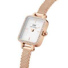 Close-up of the Quadro Mini Lumine Bezel Rose Gold watch featuring a rectangular white dial, sparkling crystal-set bezel, and an elegant rose gold mesh strap.