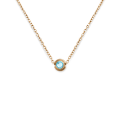 Gold necklace featuring a turquoise blue December birthstone charm set in a minimal gold-plated stainless steel pendant.