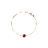 Rose gold bracelet with a central red agate stone and white cubic zirconia accents on a fine adjustable chain.