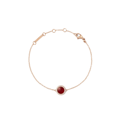 Rose gold bracelet with a central red agate stone and white cubic zirconia accents on a fine adjustable chain.