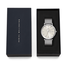 Classic Day Display Sterling Champagne watch with a silver mesh strap and champagne dial, presented in an elegant Daniel Wellington gift box.