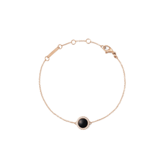 Rose gold bracelet with a black agate centrepiece, surrounded by white crystals on a delicate adjustable chain.