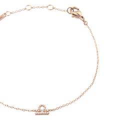 Delicate rose gold chain bracelet featuring a crystal-set zodiac pendant and adjustable sizing rings, finished with a secure lobster clasp.