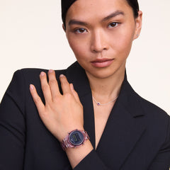 A woman wears the Retro Digital Dark Pink watch with a transparent dark pink strap and black digital dial, styled with a dark blazer and a delicate necklace for a smart, modern look.