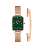 Rectangular green dial watch with a rose gold mesh strap, paired with a slim rose gold cuff bracelet engraved with the Daniel Wellington logo, both crafted in a refined, minimalist style.