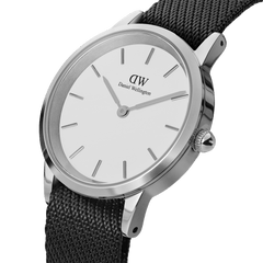 Modern classic watch with an eggshell white dial, polished silver case, and a textured black NATO strap made from recycled nylon.