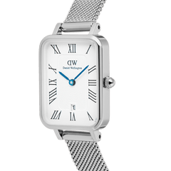 Close-up of the Quadro Sterling Roman Numerals Date watch showing its rectangular stainless steel case, white guilloché dial with Roman numerals, blue hands, and a silver mesh strap.