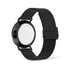 Rear view of the Daniel Wellington Classic Day Display Onyx watch, showing the engraved stainless steel case back and the adjustable black mesh strap with a secure clasp.