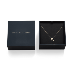 Crystal Zodiac Chain Necklace Gold with a sparkling Scorpio pendant, elegantly displayed in a black Daniel Wellington gift box.