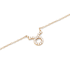 Close-up of the Crystal Zodiac Chain Necklace Gold, showcasing a Taurus zodiac pendant set with sparkling hand-set crystals on a fine gold-plated chain.