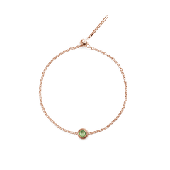Rose gold bracelet featuring a delicate chain and a round June Charm with a green crystal centre, finished with an adjustable clasp.