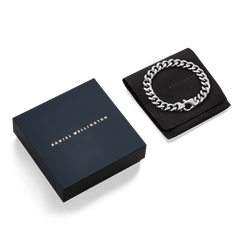 Ellipse Cuban Chain Bracelet Silver displayed on a black pouch next to an elegant Daniel Wellington gift box, highlighting its polished links and stylish presentation.
