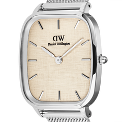 Close-up of the Daniel Wellington Marlon Sterling Linen watch, highlighting the linen-textured beige dial, minimalist silver hour markers, and polished cushion-shaped stainless steel case.
