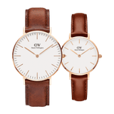 Two Daniel Wellington Classic & Petite St Mawes Rose Gold watches with minimalist white dials, slim rose gold markers, and genuine brown leather straps, displayed side by side to highlight the difference in case sizes.