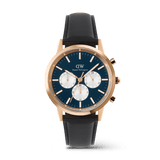 Men’s chronograph watch featuring a deep blue dial with white sub-dials, rose gold case, and black leather strap, showcasing the Iconic Chronograph Sheffield Arctic Panda Rose Gold by Daniel Wellington.