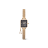 Gold rectangular women’s watch with a black mother of pearl dial, crystal-set bezel, gold mesh strap, and a sparkling zodiac charm attached, designed for a refined and personalised look.