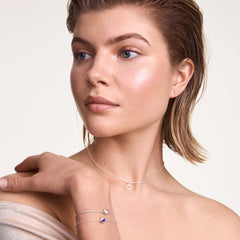 A woman wears the Charms Chain Bracelet S925 Sterling Silver on her wrist, styled with other delicate silver jewellery for a refined, layered look.