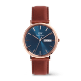 Classic Day Display St Mawes Rose Gold Arctic men’s watch featuring a textured blue dial with day and date display, rose gold stainless steel case, and a brown leather strap with pin buckle.