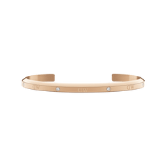 Slim rose gold open cuff bracelet with six sparkling crystals and engraved DW logos, featuring a minimalist design and polished finish.