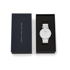Classic Piano Link Silver Unitone watch with a brushed silver dial and stainless steel piano link strap, presented in an elegant Daniel Wellington gift box.