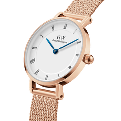 Petite Roman Numerals Melrose watch with rose gold mesh strap, white dial, Roman numerals, and blue hands.