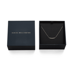 Mirelle Eternity Necklace Gold presented in an elegant black Daniel Wellington gift box, featuring a fine gold chain with a row of white cubic zirconia crystals.