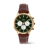 Gold chronograph watch with an emerald green dial, white sub-dials, and a brown leather strap, featuring gold-tone detailing and a classic design by Daniel Wellington.