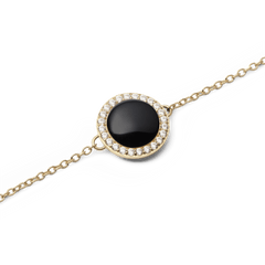 Close-up of the Audrey Bracelet Black Agathe Gold, showcasing a domed black agate stone encircled by sparkling white cubic zirconia crystals on a fine gold chain.