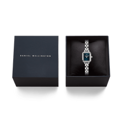 Quadro Mini Arch 3-link Arctic Sunray Silver women’s watch presented in an elegant Daniel Wellington gift box, featuring a rectangular stainless steel case and deep blue sunray dial.