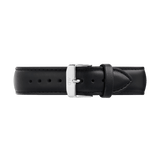 Black leather watch strap with a tapered design, detailed stitching, and a polished silver 316L stainless steel pin buckle, shown laid flat to highlight its sleek profile and refined finish.