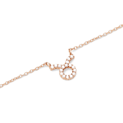 Rose gold chain necklace featuring a Taurus zodiac pendant adorned with sparkling hand-set crystals.