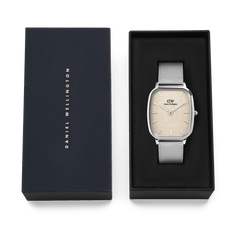 Daniel Wellington Marlon Sterling Linen watch with a silver mesh strap and linen-textured dial, elegantly presented in a black branded gift box.
