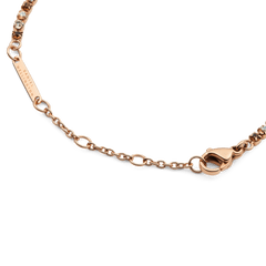 Detail of the Classic Tennis Bracelet Honey Combo Rose Gold, showing the adjustable rose gold chain, secure lobster clasp, and Daniel Wellington engraved tag.