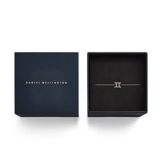 Crystal Zodiac Chain Bracelet Gold with a Gemini pendant is elegantly presented in a navy Daniel Wellington gift box.
