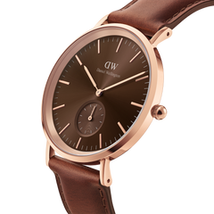 Daniel Wellington Classic Multi-Eye St Mawes Amber Rose Gold watch featuring an amber dial, rose gold stainless steel case, minimalist hour markers, and a brown leather strap.
