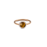 Rose gold ring with round tiger eye gemstone, haloed by white cubic zirconia, slender polished band, elegant design.