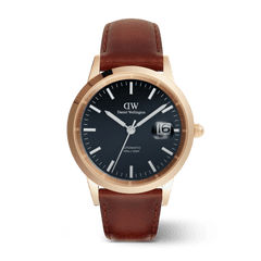 Daniel Wellington Iconic St Mawes Automatic Rose Gold watch with an arctic blue enamel dial, rose gold 40mm case, magnified date display, and brown Italian leather strap.