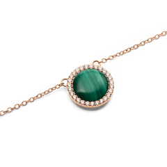 Close-up of the Audrey Necklace Malachite Rose Gold, showcasing a domed green malachite pendant encircled by a row of sparkling white cubic zirconia crystals on a fine rose gold chain.