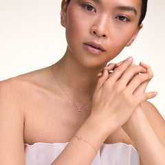 Model wearing the Crystal Zodiac Chain Necklace Silver with a sparkling Gemini pendant and a matching zodiac bracelet, styled for an elegant, minimalist look.