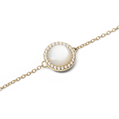Close-up of Audrey Bracelet Mother of Pearl Gold featuring a domed mother of pearl charm with cubic zirconia and fine gold chain.