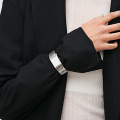 Bound 9-Link Silver women’s rectangular watch with silver strap, styled on wrist with black blazer and cream top.