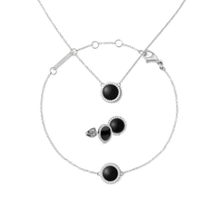 Silver jewellery set featuring a necklace, bracelet, and stud earrings, each with a round black agate centre surrounded by a halo of white crystals and set on fine silver chains. The pieces have a modern, minimalist design, ideal for both everyday wear and special occasions.