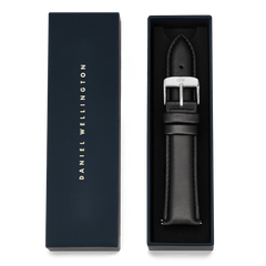 Tapered Sheffield Strap Silver presented in a navy Daniel Wellington gift box, featuring a black genuine leather watch strap with a polished silver buckle and refined stitching.
