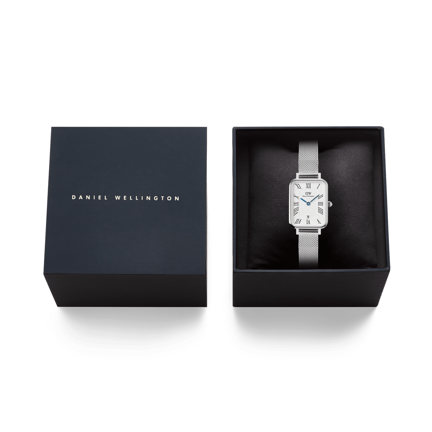 Quadro Sterling Roman Numerals Date watch with a silver mesh strap and rectangular white dial, elegantly presented in a black Daniel Wellington gift box.