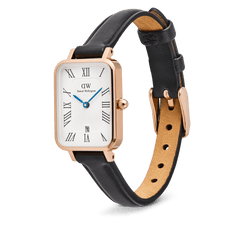 Quadro Roman Numerals Date Sheffield Rose Gold watch featuring a rectangular rose gold case, white guilloché dial with black Roman numerals, blue hands, date display at six o’clock, and a black leather strap with a rose gold buckle.