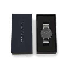 Classic Piano Link Graphite Unitone watch with a brushed graphite dial and piano link strap, presented in a signature Daniel Wellington gift box.