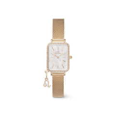 Elegant women's gold watch featuring a rectangular case with a crystal-set bezel, white mother of pearl dial, gold mesh strap, and an interchangeable crystal zodiac charm attached to the bracelet.
